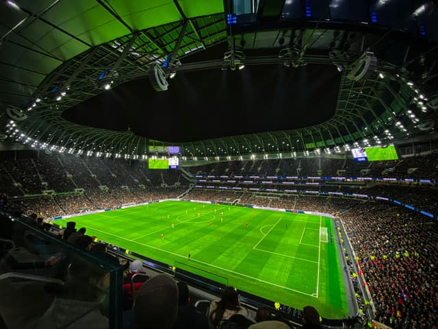 Packed stadium under floodlights during a night match