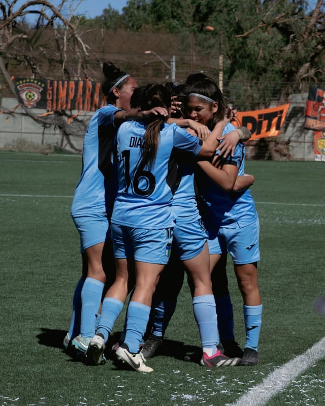 Football team celebrating a goal together